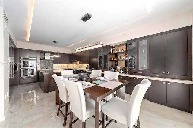 dining space featuring marble finish floor