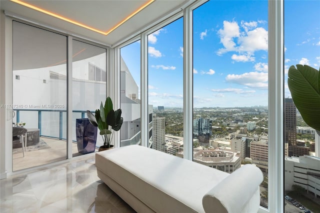 bedroom featuring floor to ceiling windows and a city view