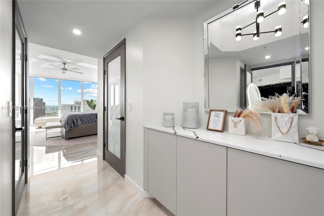 corridor featuring baseboards, a view of city, french doors, floor to ceiling windows, and recessed lighting