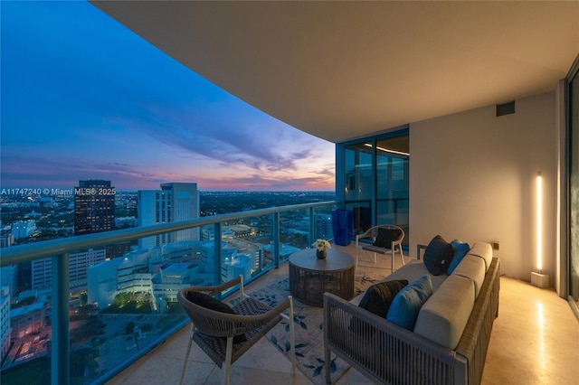 balcony featuring outdoor lounge area, visible vents, and a city view