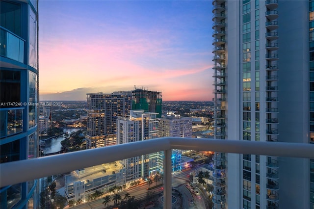 balcony featuring a city view and a water view