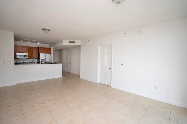 1300 Ponce De Leon Blvd Unit 709, Coral Gables, FL 33134 - unfurnished living room featuring track lighting, light tile patterned flooring, visible vents, and baseboards