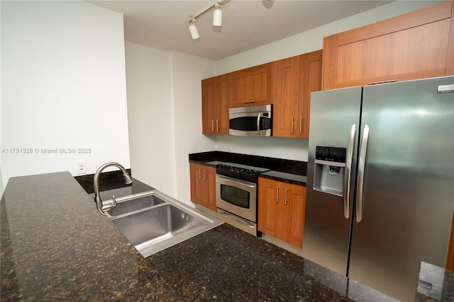 1300 Ponce De Leon Blvd Unit 709, Coral Gables, FL 33134 - kitchen with brown cabinets, dark stone countertops, a sink, and appliances with stainless steel finishes