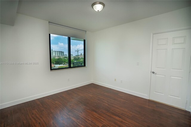 1300 Ponce De Leon Blvd Unit 709, Coral Gables, FL 33134 - empty room with baseboards and dark wood-style flooring