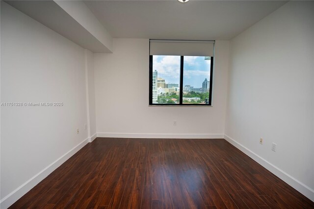 1300 Ponce De Leon Blvd Unit 709, Coral Gables, FL 33134 - spare room with dark wood-style flooring and baseboards