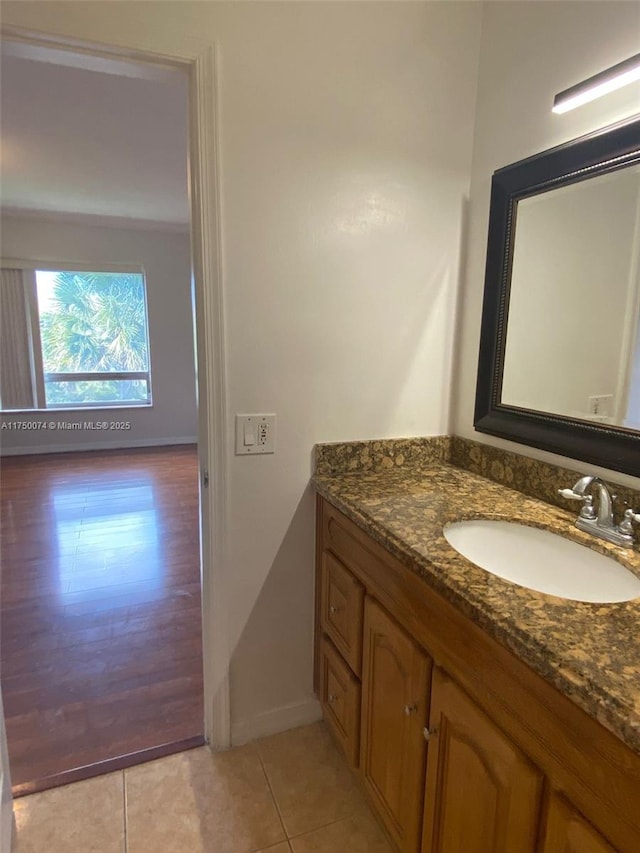 bathroom with tile patterned flooring, vanity, and baseboards