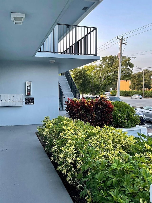 exterior space with stairway and stucco siding