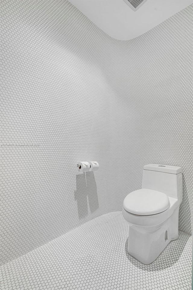 bathroom featuring toilet and tile patterned floors