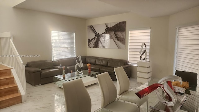 living room featuring marble finish floor and stairway