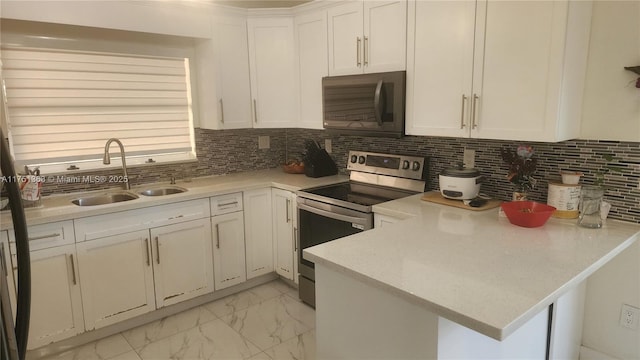 kitchen with electric range, a sink, white cabinets, marble finish floor, and decorative backsplash