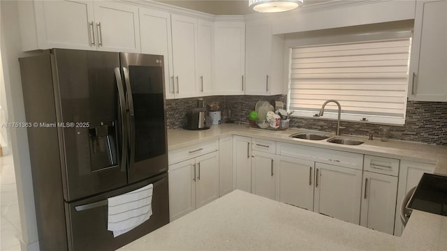 kitchen with stainless steel appliances, white cabinets, light countertops, and a sink