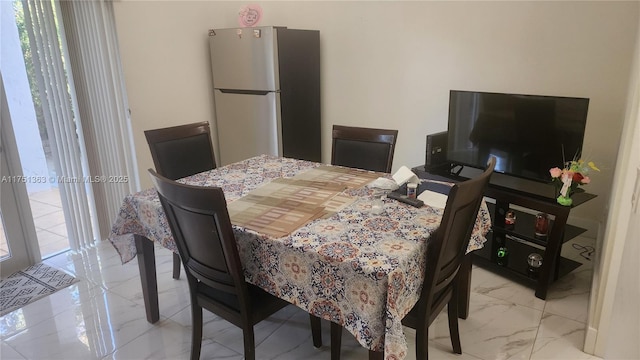 dining area with marble finish floor and plenty of natural light