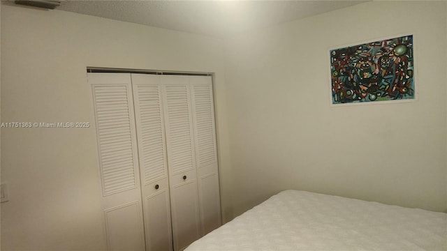 bedroom featuring a closet and visible vents