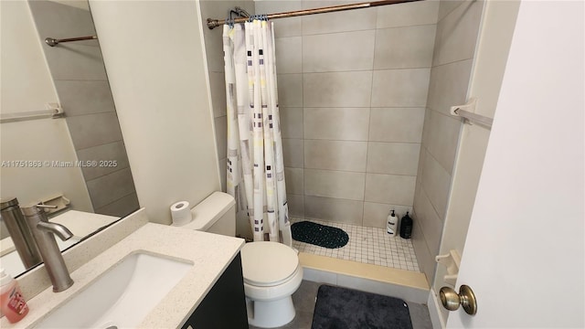 full bathroom featuring a stall shower, vanity, and toilet