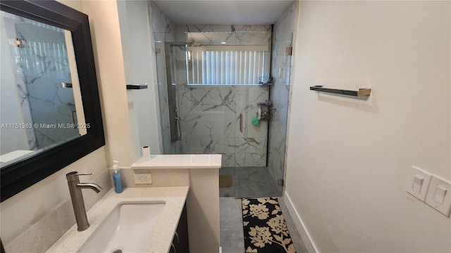 full bathroom with a marble finish shower and vanity