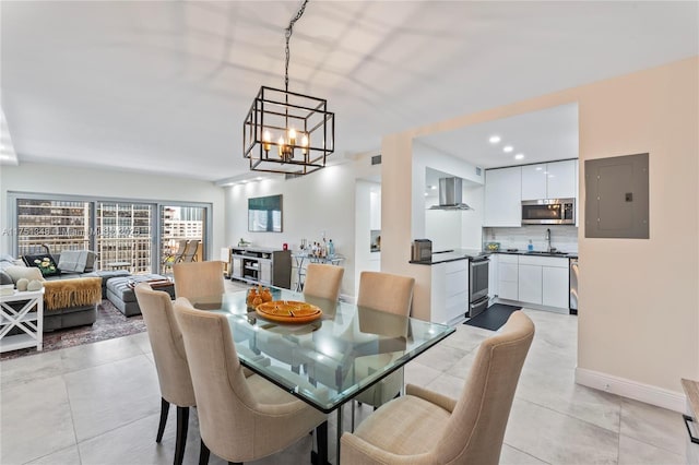 dining space featuring light tile patterned floors, electric panel, baseboards, and an inviting chandelier