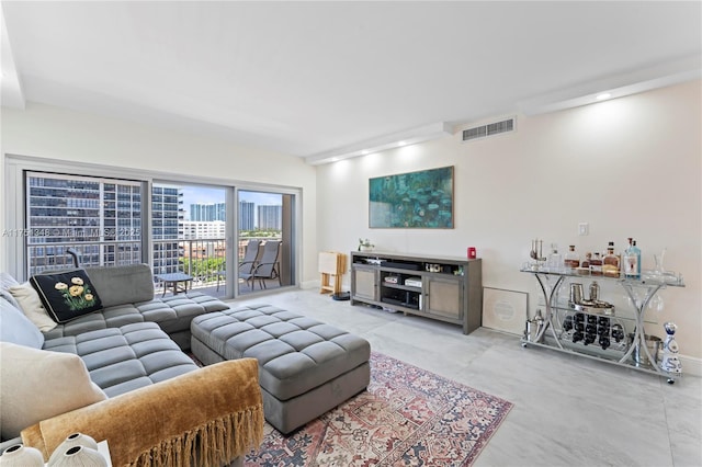 living room featuring a view of city, visible vents, and baseboards