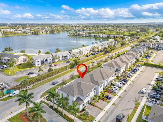 birds eye view of property featuring a water view and a residential view