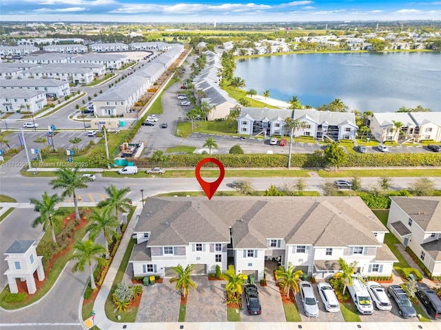 birds eye view of property featuring a water view and a residential view