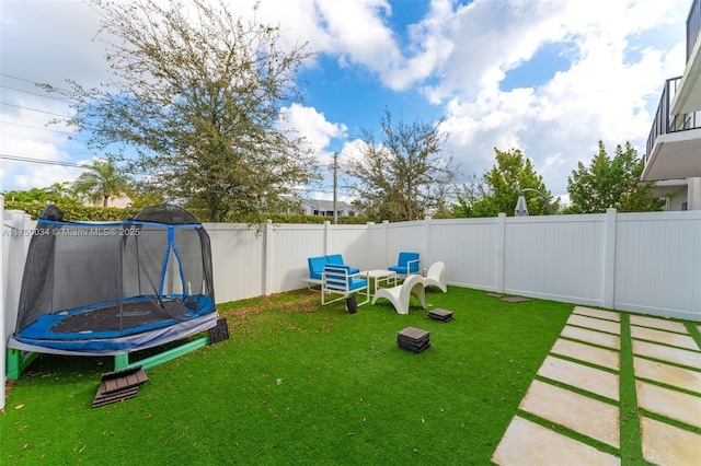 view of yard featuring a fenced backyard and a trampoline