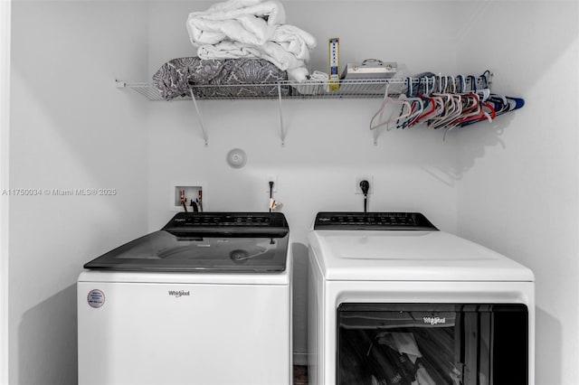 clothes washing area featuring laundry area and washer and clothes dryer