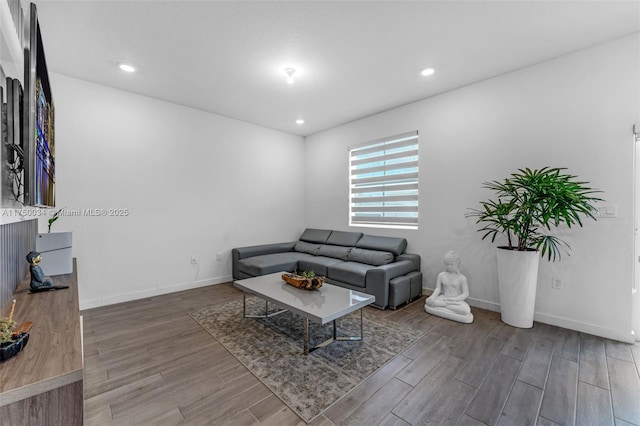 living room with recessed lighting, wood finished floors, and baseboards