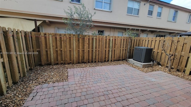 view of patio with cooling unit and a fenced backyard