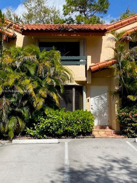 mediterranean / spanish-style house featuring a tile roof and stucco siding