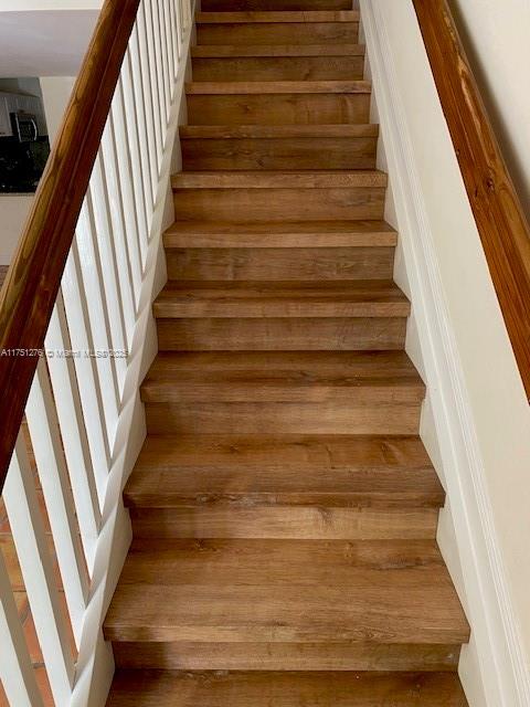 stairs with wood finished floors