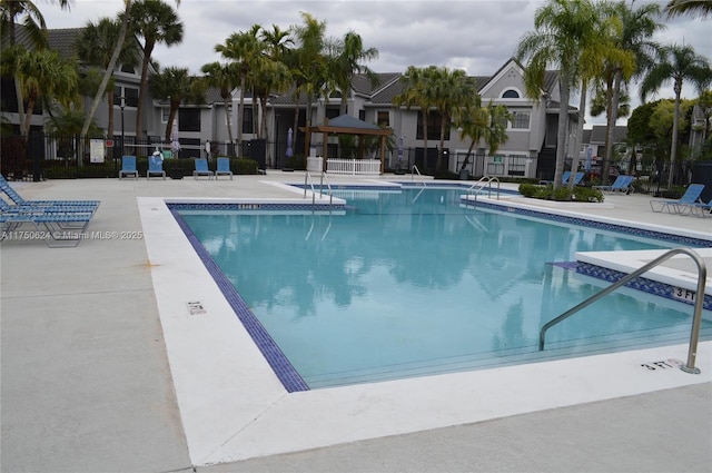 pool featuring a patio, a gazebo, and fence