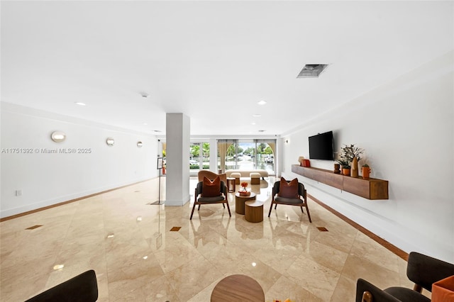 living area with recessed lighting, marble finish floor, and baseboards