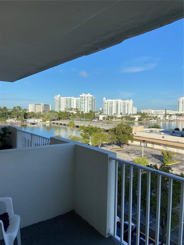 balcony with a water view and a city view