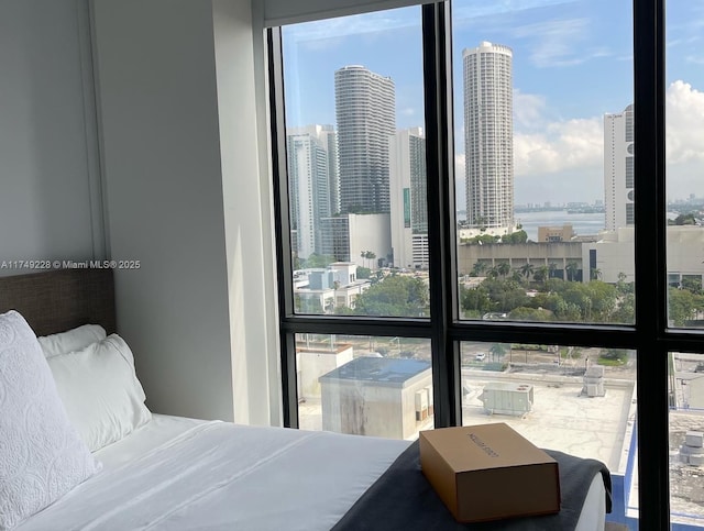 bedroom featuring floor to ceiling windows and a city view