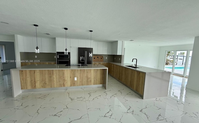 kitchen with light countertops, a sink, and white cabinets