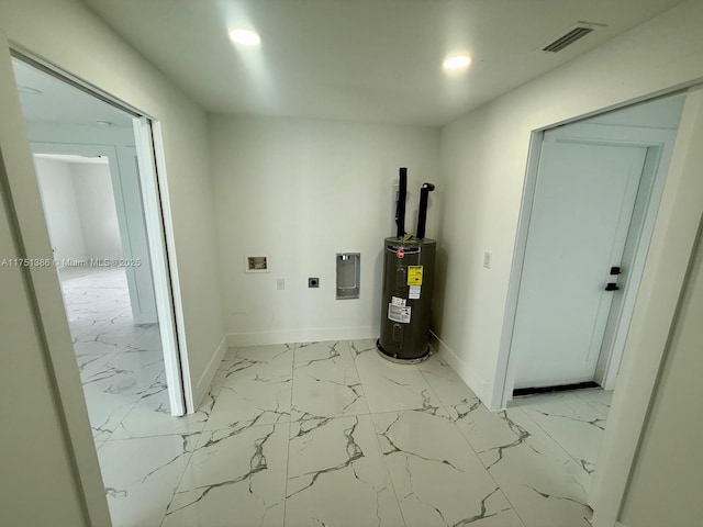 utility room with electric panel, visible vents, and electric water heater