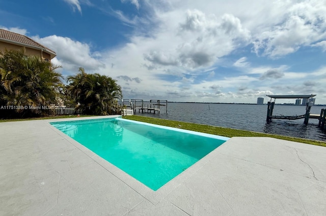 view of pool featuring a dock, a water view, fence, and boat lift