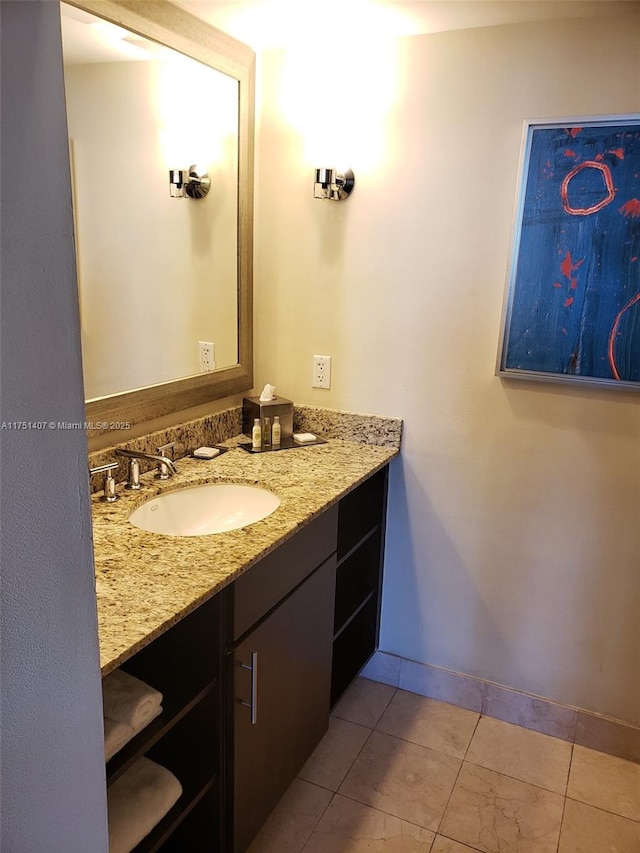 bathroom with tile patterned flooring, vanity, and baseboards