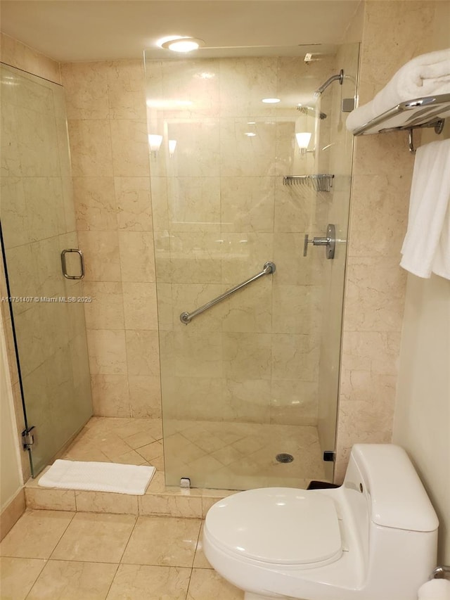 full bathroom with toilet and a shower stall