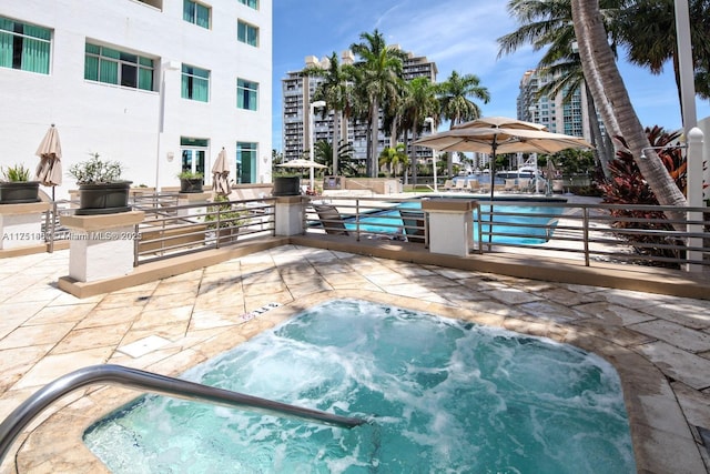 view of pool with a patio area and a community hot tub