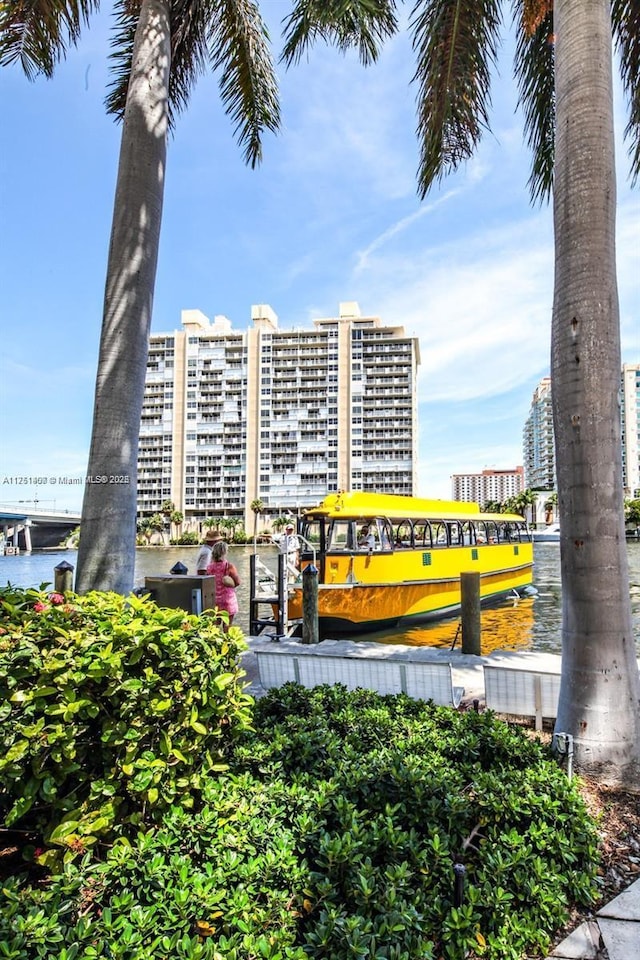 view of building exterior featuring a water view and a city view