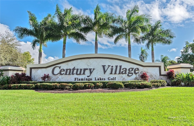 community / neighborhood sign with a yard