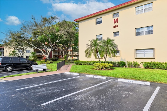 view of building exterior featuring uncovered parking