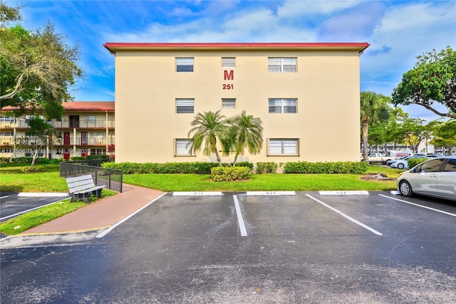 view of building exterior with uncovered parking