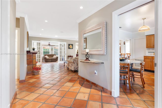 hallway with recessed lighting, visible vents, baseboards, crown molding, and light tile patterned flooring