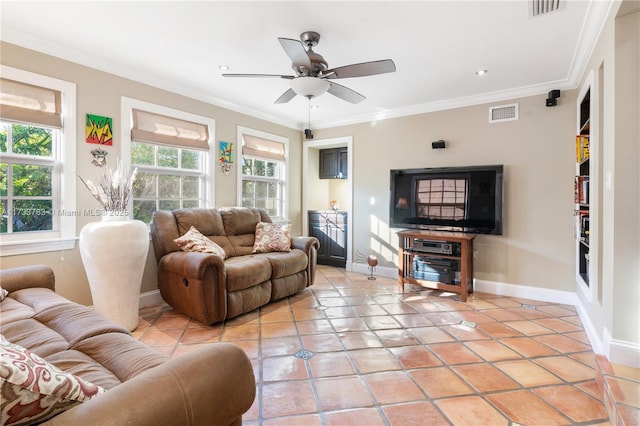 living area with ornamental molding, visible vents, and baseboards