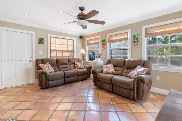 living area with baseboards, a healthy amount of sunlight, and crown molding