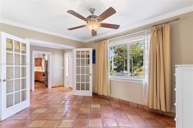 unfurnished room featuring french doors, crown molding, baseboards, and ceiling fan