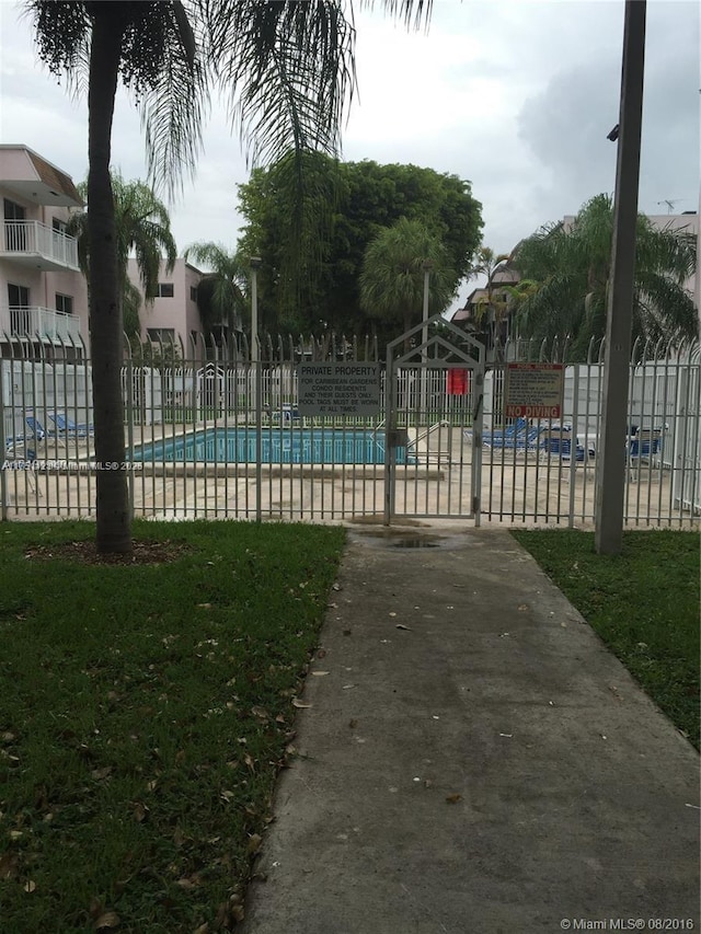 community pool with fence and a gazebo