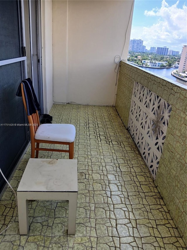 balcony with a water view and a city view