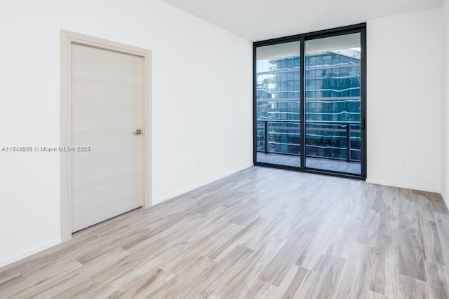 801 S Miami Ave Unit 1808, Miami, FL 33130 - empty room with expansive windows and wood finished floors
